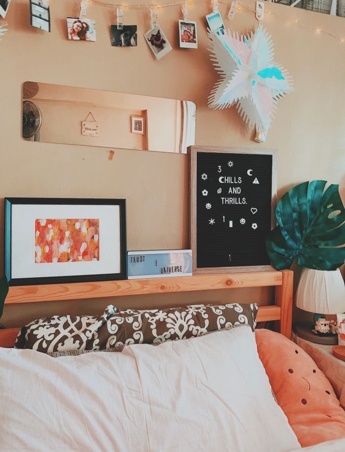 A well-decorated bedroom with cozy accents and artistic decor elements.